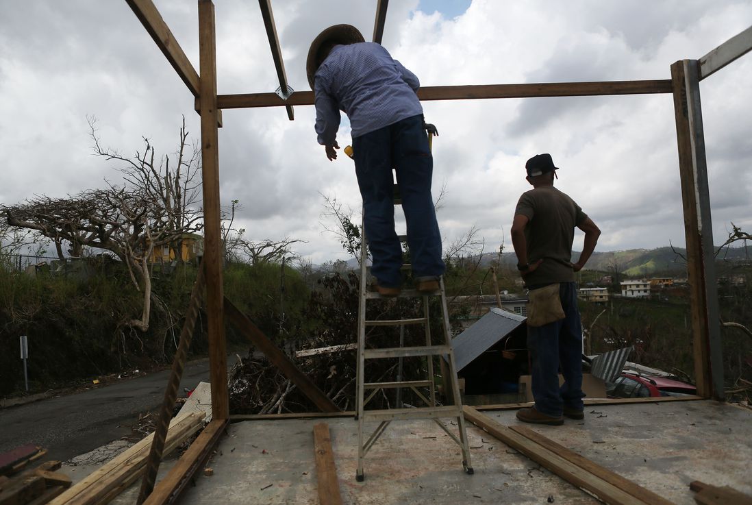 Men work repairing a partially destroyed bar three weeks after Hurricane Maria hit the island, on October 11, 2017 in Aibonito, Puerto Rico. <br/>